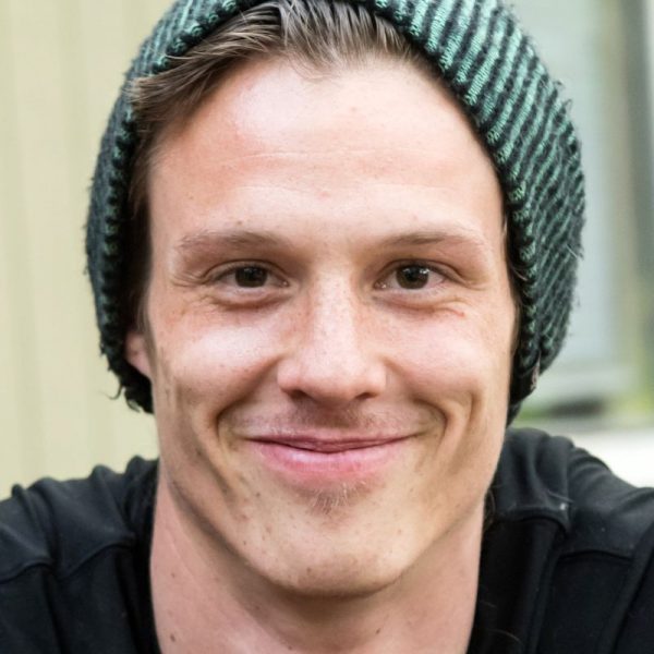Close up image of a man wearing a beanie