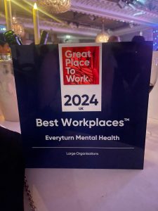 Everyturn Mental Health's "UK's Best Workplaces" trophy on a table
