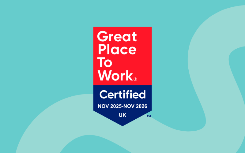 A blue background with a blue squiggly line. In the middle is a Great Place To Work accreditation badge for 2025-2026.
